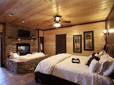 Romantic bedroom with a king size bed, jacuzzi tub and fireplace in the bedroom